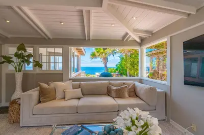 a living room with a couch and a view of the ocean at Dolphin's Paradise in San Diego