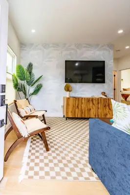 a living room with a flat screen tv on a wall at Newly Remodeled Uptown Chic in San Diego