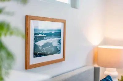 a picture frame hanging on a wall next to a lamp at Quaint Studio in Charming Marston Hills in San Diego