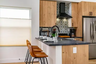 a kitchen with a counter and some chairs in it at Swanky Studio in Vibrant Hillcrest in San Diego