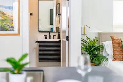 a living room with a sink and a couch at Swanky Studio in Vibrant Hillcrest in San Diego