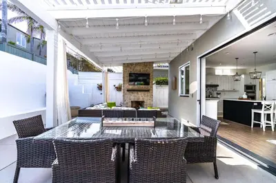 a patio with a table and chairs and a kitchen at Upscale Beach Cottage a Block to the Beach Sauna in Encinitas