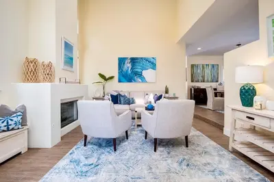 a living room with a table and chairs and a fireplace at Upscale Beach Cottage a Block to the Beach Sauna in Encinitas