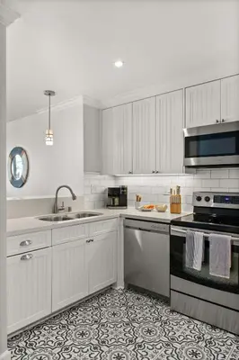 a white kitchen with a sink and a stove at Mission Beach Marvel in San Diego