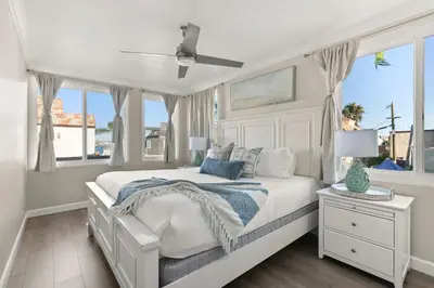 a white bedroom with a bed and windows at Mission Beach Marvel in San Diego