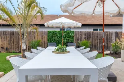 a white table with chairs and an umbrella at Luxury Home with Views 15 Min to DT & Coronado Beach in San Diego