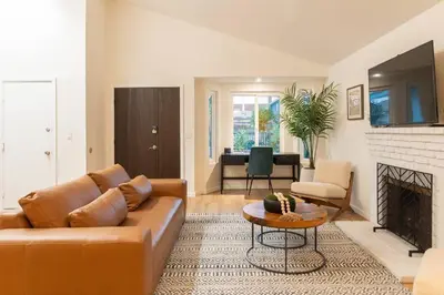 a living room with a couch and a fireplace at Luxury Home with Views 15 Min to DT & Coronado Beach in San Diego