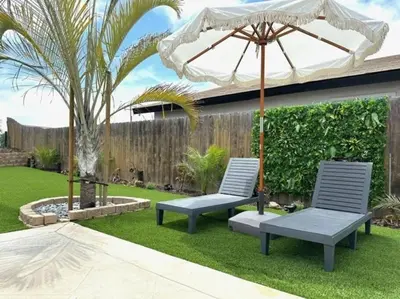 two chairs and an umbrella in a yard at Luxury Home with Views 15 Min to DT & Coronado Beach in San Diego