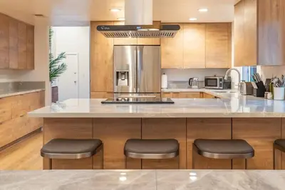 a kitchen with a large counter with stools at Luxury Home with Views 15 Min to DT & Coronado Beach in San Diego