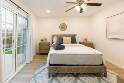 a bedroom with a large bed and a ceiling fan at Luxury Home with Views 15 Min to DT & Coronado Beach in San Diego