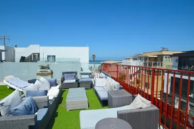 a patio with couches and chairs on a balcony at Ocean View 5 BR with 3 decks and spa in San Diego