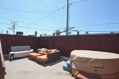a patio with a couch and a bed on a fence at Ocean View 5 BR with 3 decks and spa in San Diego