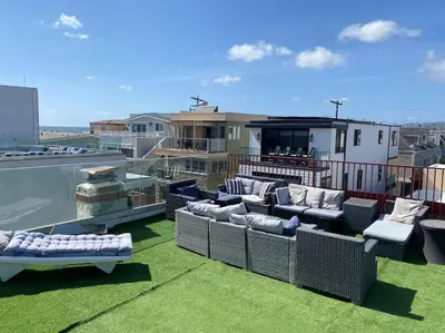 a rooftop patio with couches on a roof at Ocean View 5 BR with 3 decks and spa in San Diego