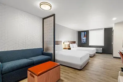 a hotel room with a bed and a couch at Everhome Suites Temecula in Temecula