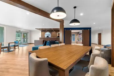 a dining room with a wooden table and chairs at Everhome Suites Temecula in Temecula