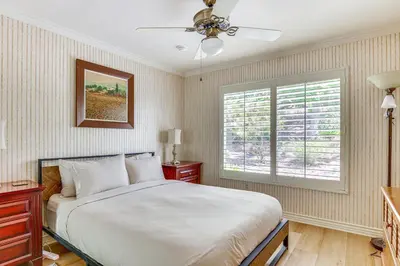 a bedroom with a large bed and a window at Escondido Townhome with Gas Grill and Golf Acess! in Escondido