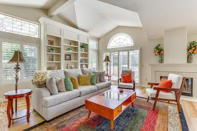 a living room with a couch and a table at Escondido Townhome with Gas Grill and Golf Acess! in Escondido