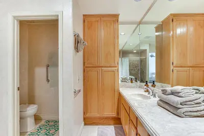 a bathroom with a sink and a toilet and a mirror at Escondido Townhome with Gas Grill and Golf Acess! in Escondido