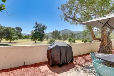 a patio with a table and an umbrella at Escondido Townhome with Gas Grill and Golf Acess! in Escondido