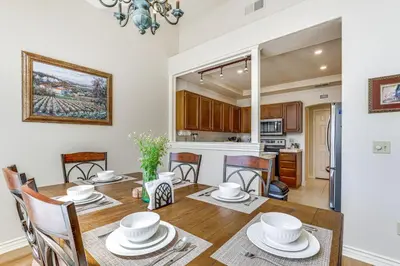 a dining room and kitchen with a table and chairs at Escondido Townhome with Gas Grill and Golf Acess! in Escondido