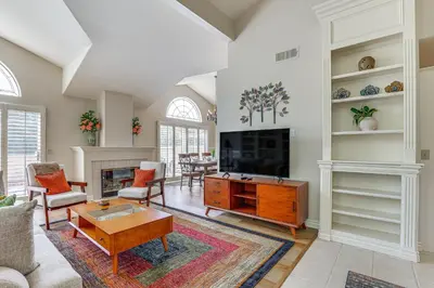 a living room with a couch and a table at Escondido Townhome with Gas Grill and Golf Acess! in Escondido