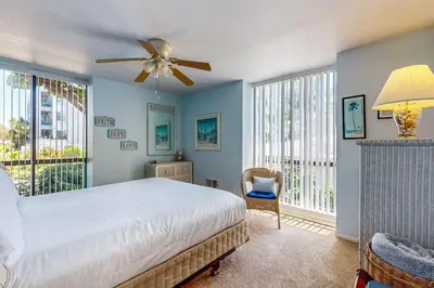 a bedroom with a bed and a ceiling fan at Breakwater Escape A 200 in Oceanside