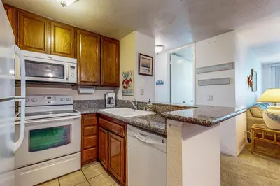 a kitchen with a sink and a microwave at Breakwater Escape A 200 in Oceanside
