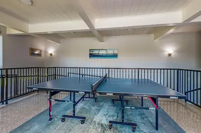 a ping pong table in the middle of a room at Breakwater Escape A 200 in Oceanside