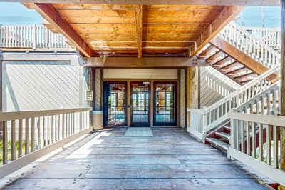 a wooden walkway to a house with a wooden ceiling at Breakwater Escape A 200 in Oceanside