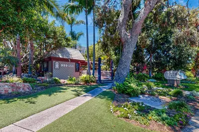 a garden with a small shed and a tree at Breakwater Escape A 200 in Oceanside