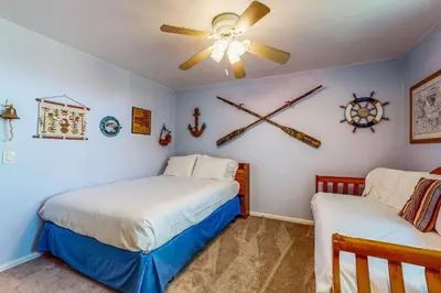 a bedroom with two beds and a ceiling fan at Breakwater Escape A 200 in Oceanside