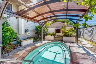 a swimming pool in a backyard with a pergola at Breakwater Escape A 200 in Oceanside