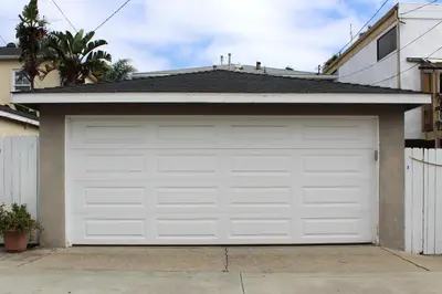 a white garage door in front of a house at 1009 W Bay in Newport Beach