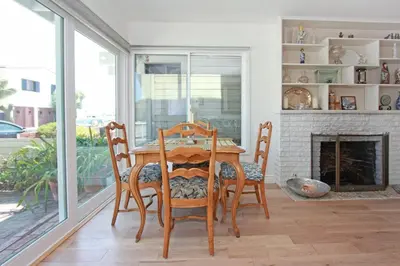 a dining room with a table and chairs and a fireplace at 1009 W Bay in Newport Beach