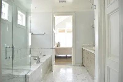 a bathroom with a tub and a glass shower at 1028 W Oceanfront in Newport Beach