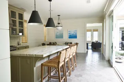 a kitchen with a large island with stools at 1028 W Oceanfront in Newport Beach
