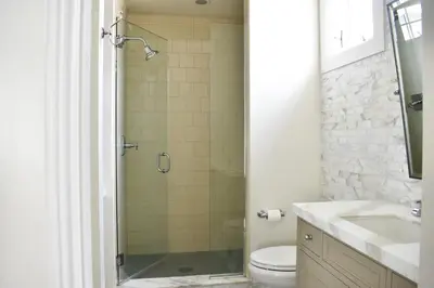 a bathroom with a shower and a toilet and a sink at 1028 W Oceanfront in Newport Beach