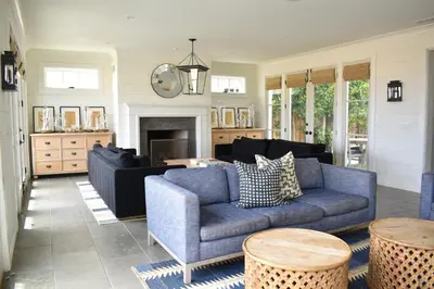 a living room with two blue couches and a fireplace at 1028 W Oceanfront in Newport Beach