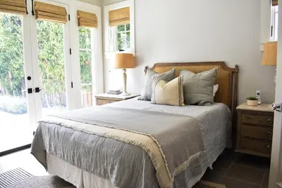 a bedroom with a bed with pillows and a window at 1028 W Oceanfront in Newport Beach