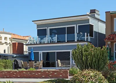 a house with chairs and tables on the balcony at 1023 E Balboa B in Newport Beach