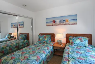 a bedroom with two beds and a mirror at 1023 E Balboa B in Newport Beach