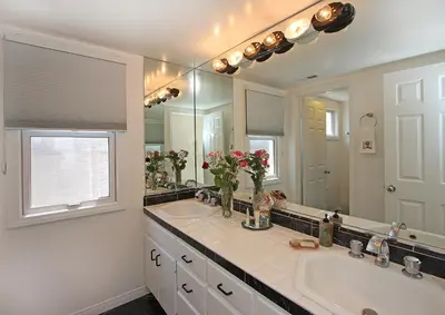 a bathroom with two sinks and a large mirror at 1023 E Balboa B in Newport Beach