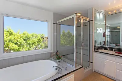 a white bathroom with a tub and a window at 1023 E Balboa B in Newport Beach