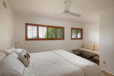 a white bedroom with a bed and a couch at La Jolla Shores Family Getaway in San Diego