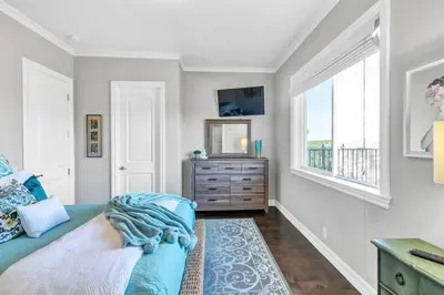 a bedroom with a bed and a dresser and a window at Luxurious Mansion in Wine Country in Temecula