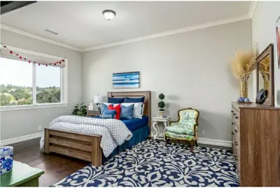 a bedroom with a blue bed and a chair at Luxurious Mansion in Wine Country in Temecula