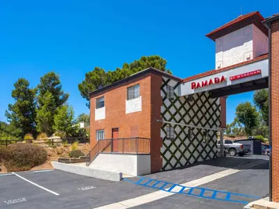 a parking lot in front of a parking garage at Ramada by Wyndham San Diego Poway Miramar in Poway