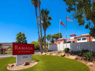 a sign for ramada by wyndham in front of a building at Ramada by Wyndham San Diego Poway Miramar in Poway