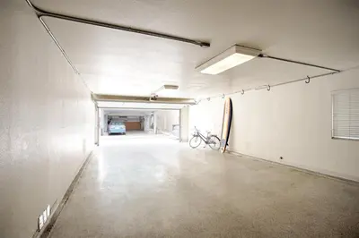an empty parking garage with a bike parked in it at Lower West Newport in Newport Beach