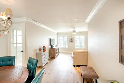 a living room with a table and chairs and a dining room at Lower West Newport in Newport Beach